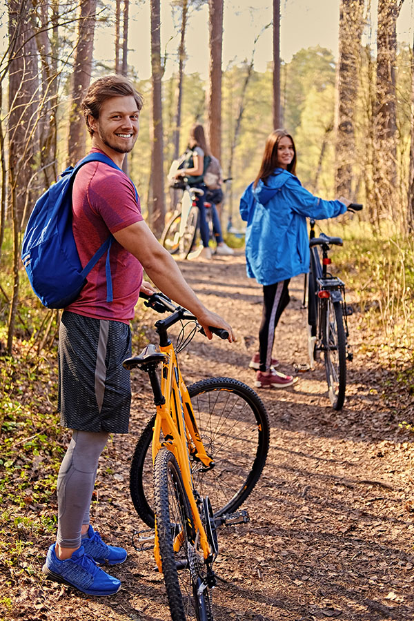 Smiling sporty man holds mountain bicycle.Summer time